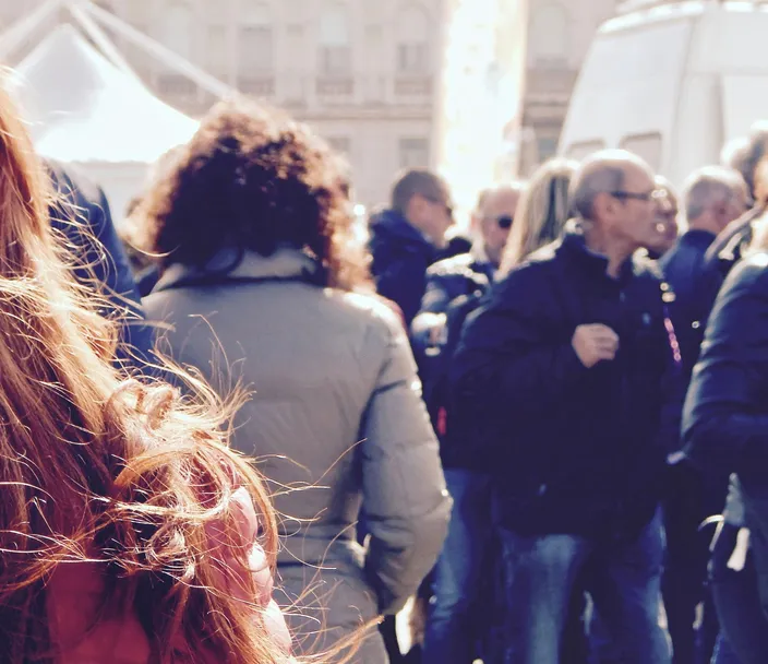 A crowd of people walking in a city street