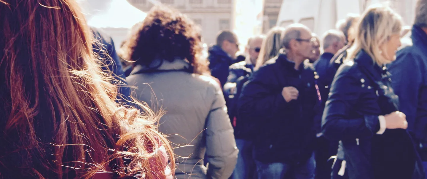 A crowd of people walking in a city street
