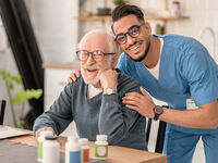male nurse with a pensioner in the kitchen